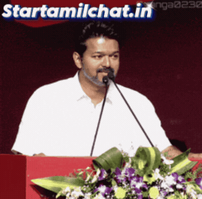Man Speaking Into Microphone At Podium With Starttamilchat.in GIF