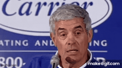 Man Speaking Into Microphone In Front Of Carrier Logo GIF