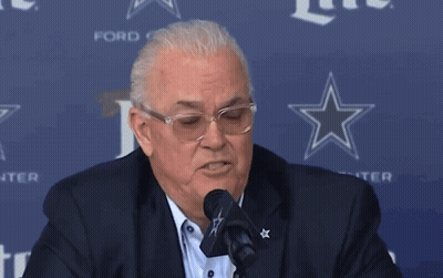 Man Speaking Into Microphone In Front Of Ford Sign GIF