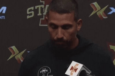 Man Speaking Into Microphone In Front Of State Sign GIF