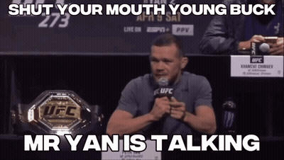 Man Speaking Into Microphone In Front Of UFC Championship Belt GIF