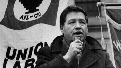 Man Speaking Into Microphone In Front Of Union Labs Flag GIF