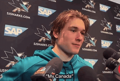 Man Speaking Into Microphone With My Canada Behind Him GIF