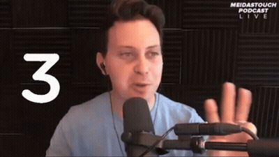 Man Speaking Into Microphone With Number 3 GIF