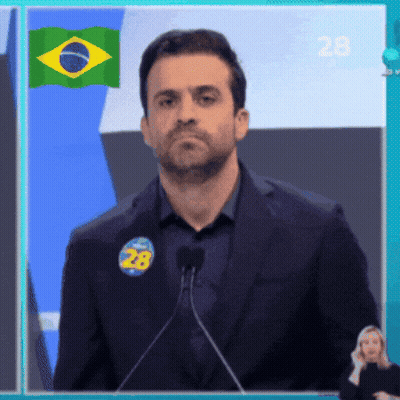 Man Speaking Into Microphone With Sticker Saying 28 GIF