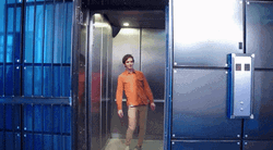 Man Spinning His Hips Inside Elevator GIF