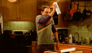 Man Spraying Air Freshener On Kitchen Counter GIF