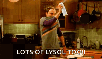 Man Spraying Lysol On Kitchen Counter GIF