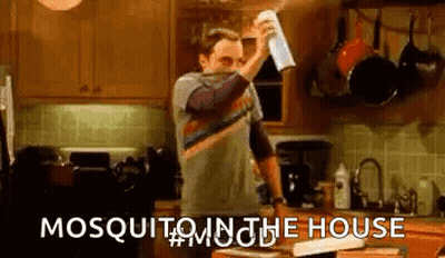 Man Spraying Paper Towel With Mosquito Killer In Kitchen GIF