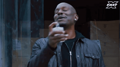 Man Spraying Perfume Bottle With X Fast Logo GIF