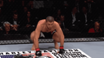 Man Squatting At Harley Davidson Sign GIF