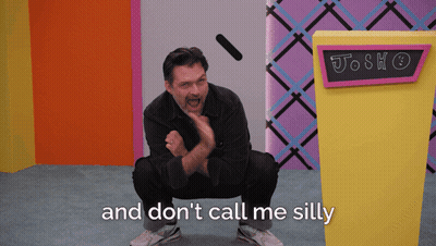 Man Squatting In Front Of Josh Don't Call Me Silly Sign GIF