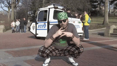 Man Squatting in Front of NYPD Police Car
