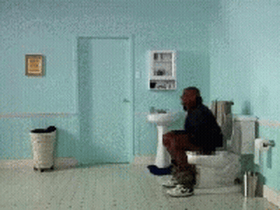 Man Squatting On Toilet In Blue Bathroom GIF