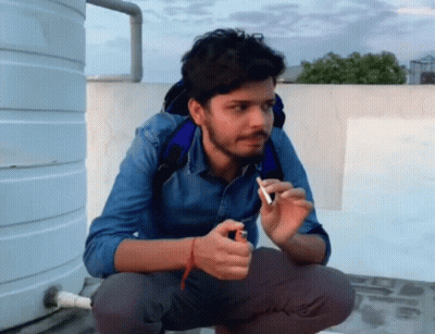 Man Squatting With Lighter And Cigarette GIF
