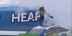 Man Standing As Winner Above Race Car GIF