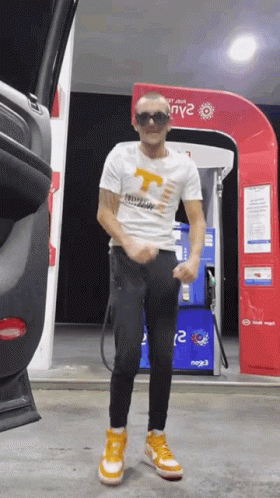 Man Standing At Gas Pump GIF
