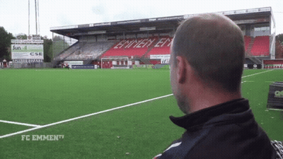 Man Standing At Soccer Field With FC Emmen TV Sign GIF