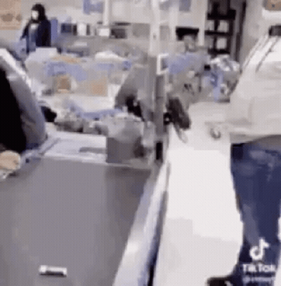 Man Standing At Store Counter GIF