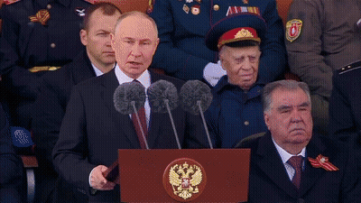 Man Standing At Ura Podium GIF