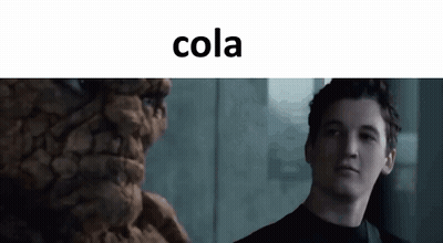 Man Standing Before Cola Statue GIF