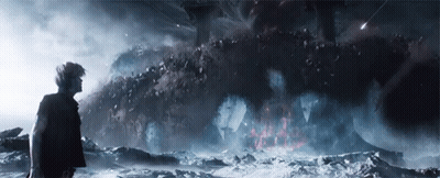 Man Standing Before Desert Rock Formation GIF
