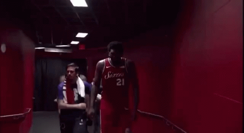 Man Standing Before Exit Sign GIF