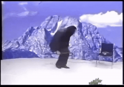 Man Standing Before Mountain And Chair GIF