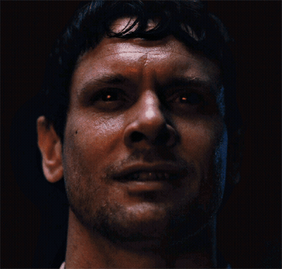 Man Standing Before Skull Crowd GIF
