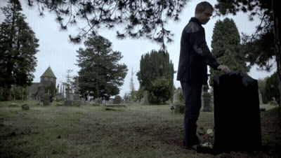 Man Standing By Grave In Cemetery GIF