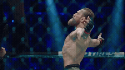 Man Standing In Boxing Ring With Arms Out GIF