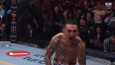 Man Standing In Boxing Ring With Arms Out GIF