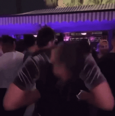Man Standing In Crowd At Party GIF
