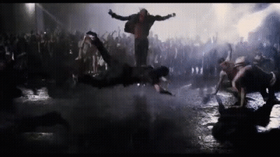 Man Standing In Crowd Of Zombies GIF