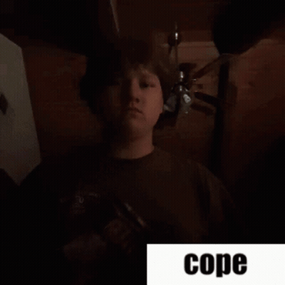 Man Standing In Dark Room Saying Cope GIF