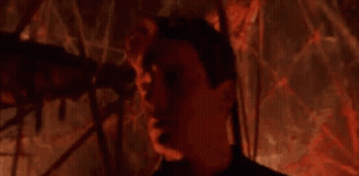 Man Standing in Dark Room Saying Welcome