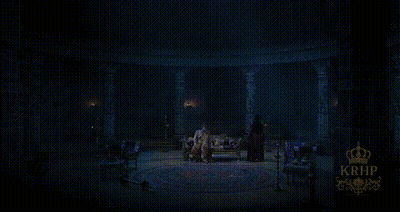 Man Standing In Dark Room With Crown GIF