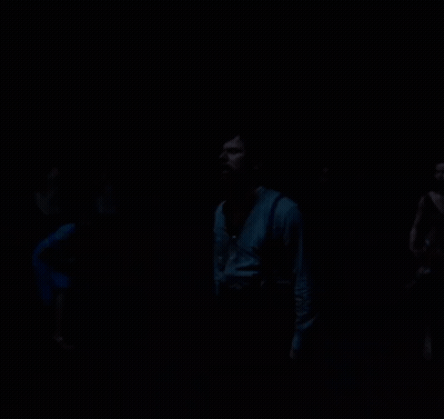 Man Standing In Darkness Looking Up GIF