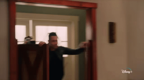 Man Standing In Doorway With Disney Plus GIF