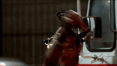 Man Standing In Front Of Ambulance With Arm Raised GIF