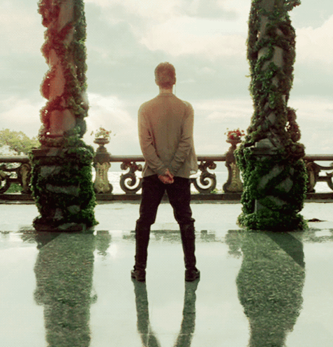 Man Standing In Front Of Balcony GIF