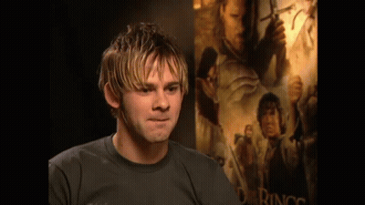 Man Standing In Front Of Big Poster GIF