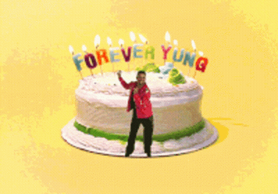 Man Standing In Front Of Birthday Cake Saying Forever Young GIF