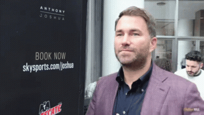 Man Standing In Front Of Book Now Sign GIF