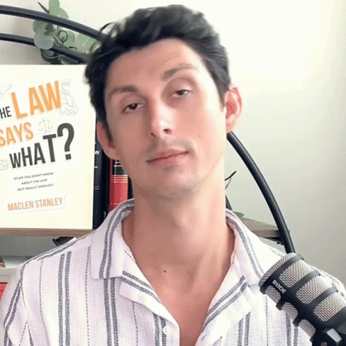 Man Standing In Front Of Book Saying What GIF