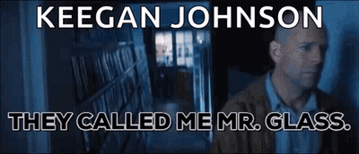 Man Standing In Front Of Bookshelf Saying Mr. Glass GIF