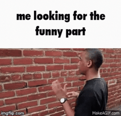Man Standing In Front Of Brick Wall Looking For Funny Part GIF