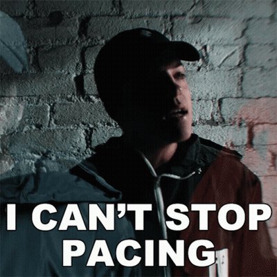 Man Standing In Front Of Brick Wall Saying I Can't Stop Pacing GIF