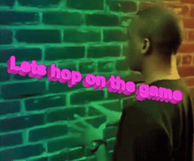 Man Standing In Front Of Brick Wall Saying Let's Hop On The Game GIF
