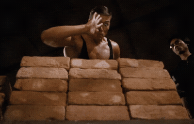 Man Standing In Front Of Bricks GIF